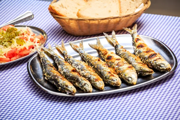 Grilled sardines with salad, bread and potato — Stock Photo, Image