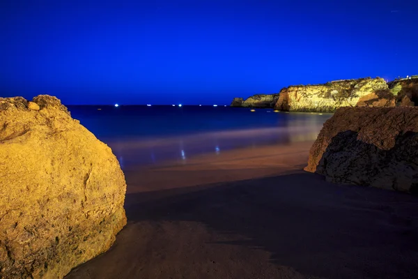 Lagos Beach with cliffs and fishermen 's boat, Portugal — стоковое фото