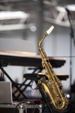 Saxophone on the stage before a concert clipart