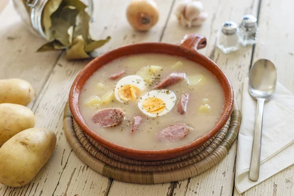 Traditional polish soup called Zurek nicely arranged with veggie