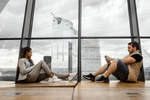 Loneliness Big City Couple Sitting Together Huge Glass Window Thinking — Stock Photo, Image