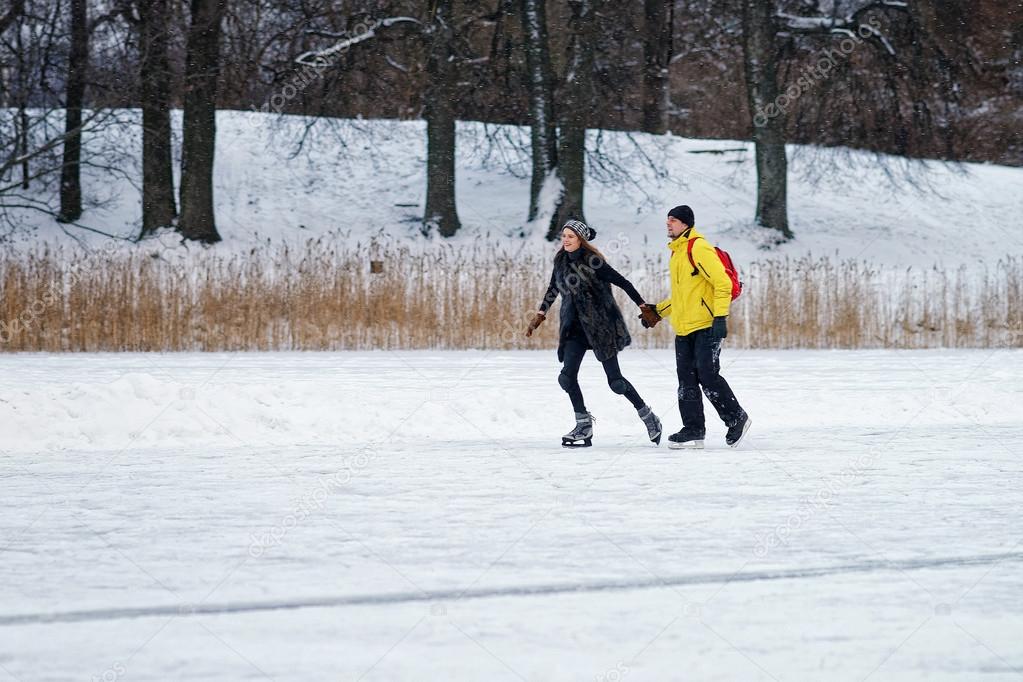 Young girl and man ice skating Trakai in Lithuania