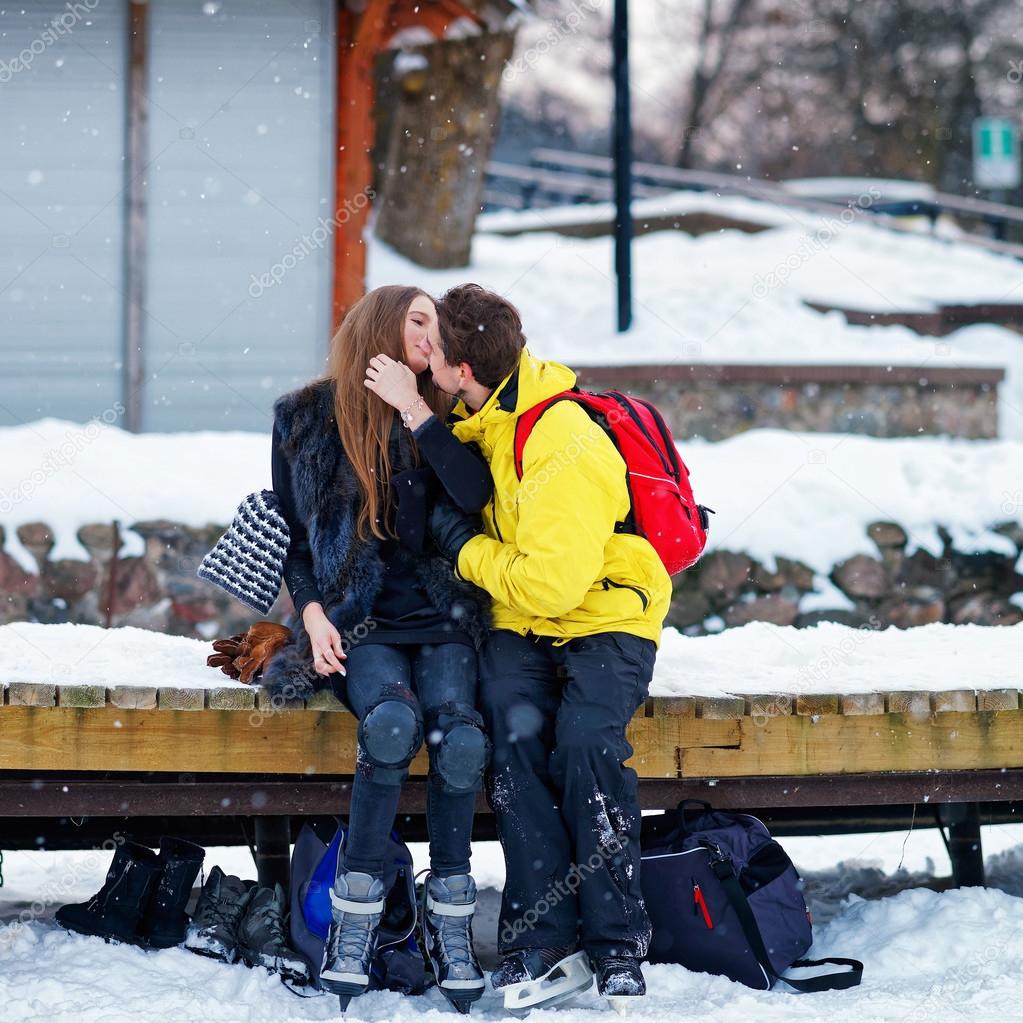 Young fellow and girl kissing at the rink in Trakai