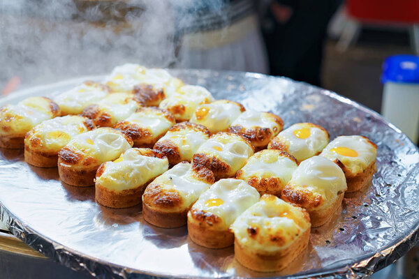 Buns with fried egg in Myeongdong open street market Seoul