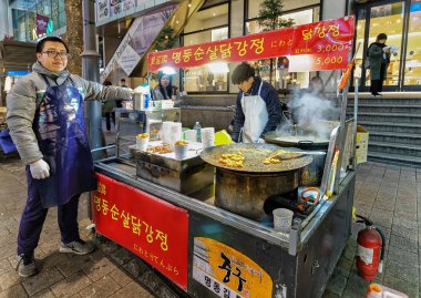 Seul Myeongdong açık semt pazarı gıda satan adam
