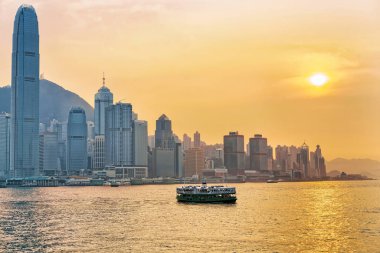 Star ferry at the Victoria Harbor of HK at sundown clipart