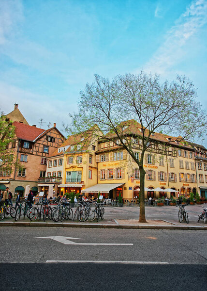 Strasbourg, France - April 30, 2012: Restaurants at Place du Corbeau Square in the old town in Strasbourg, Krutenau, France. People on the background