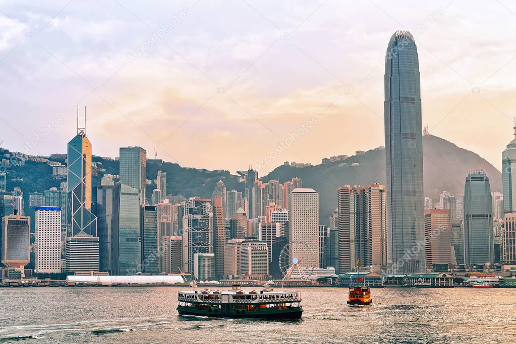 Star ferry in Victoria Harbor in Hong Kong at sunset