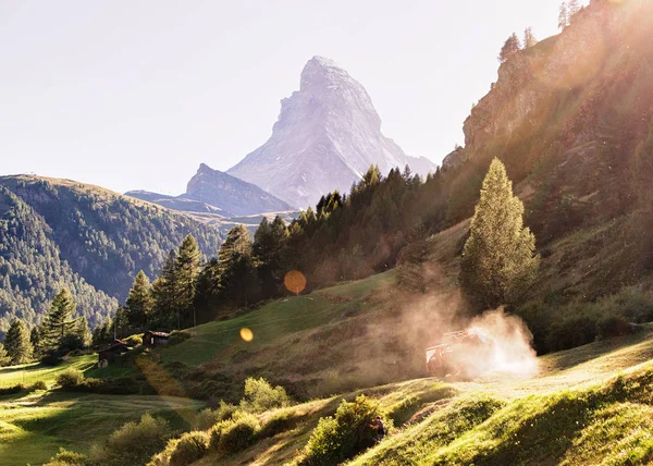 Matterhorn mountain and agricultural works in Zermatt with sun flare