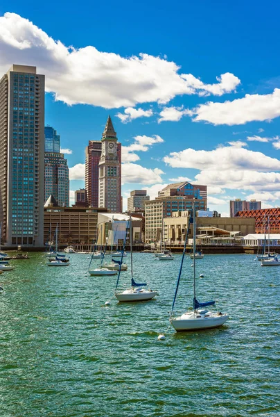 Floating sailboats and the skyline of Financial District in Boston