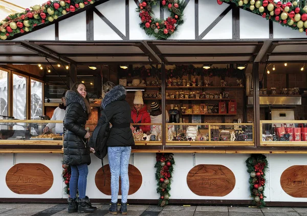 Menschen im Souvenirhaus auf dem Weihnachtsmarkt in Vilnius — Stockfoto