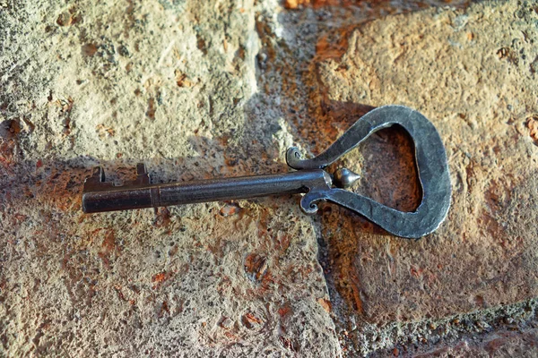 Old key at stone background