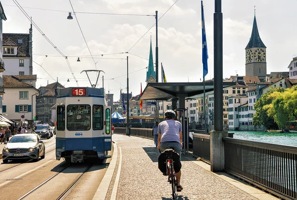 Running Tram and man riding bicycle at Limmatquai in Zurich — Stock Photo, Image