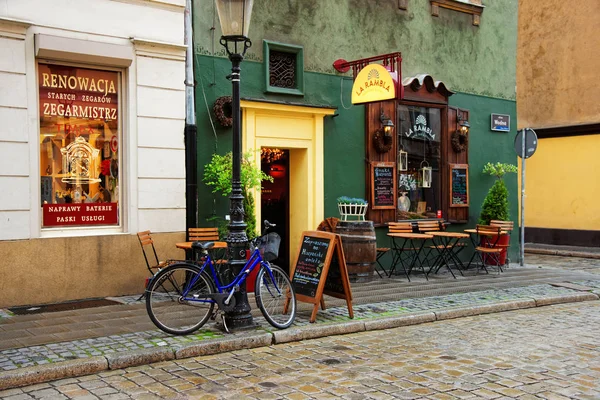Bicycle at Cozy street cafe in Old city in Poznan — Stock Photo, Image