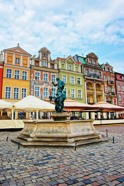 Poznan, Poland - May 7, 2014: Fountain of Neptune at the Old Market Square, Poznan, Poland. People on the background