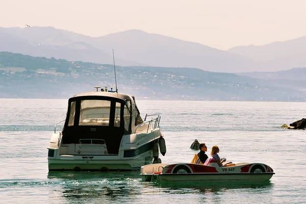 Barco a motor y personas en catamarán en el lago Lemán Lausana — Foto de Stock