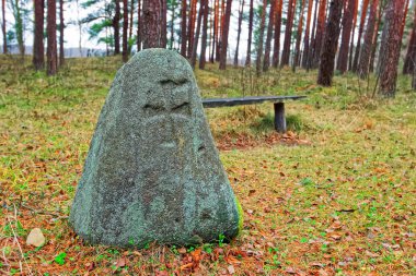 Stone sculpture at Ethnographic open air village in Riga clipart