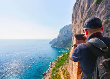 Man taking photos of Marina Piccola on Capri Island clipart