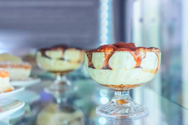 Selection of frozen tiramisu in fridge on display cafe Positano