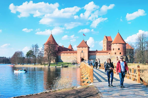 Parejas jóvenes en el castillo de la isla de Trakai en el lago Galve — Foto de Stock