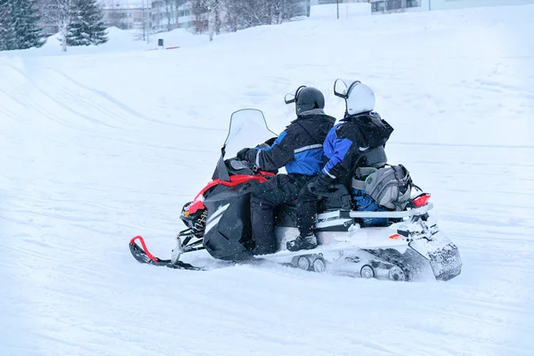 Pessoas montando snowmobile no lago de neve congelado no inverno Rovaniemi — Fotografia de Stock