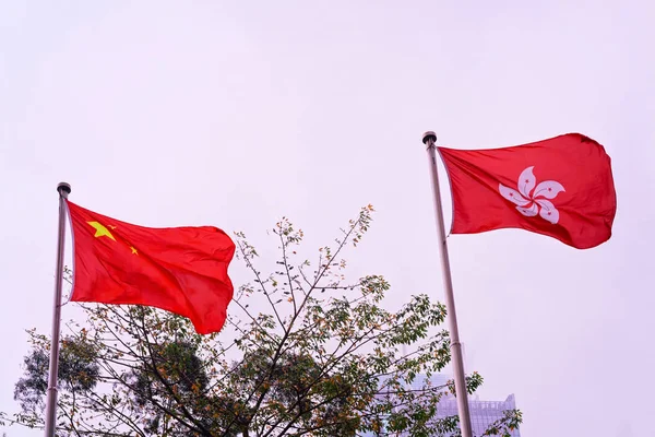 Hong Kong flag and Flag of China in fog