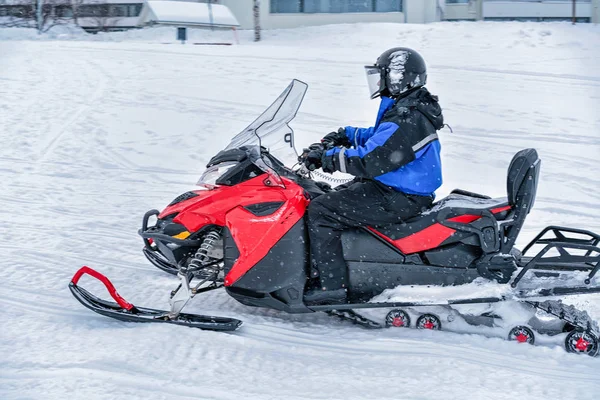 Person fährt Schneemobil auf zugefrorenem See im Winter rovaniemi — Stockfoto