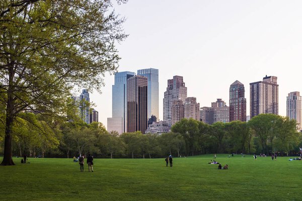 New York, USA - May 6, 2015: View of Midtown Manhattan skyline in Central Park South, in New York, NYC, USA. People nearby