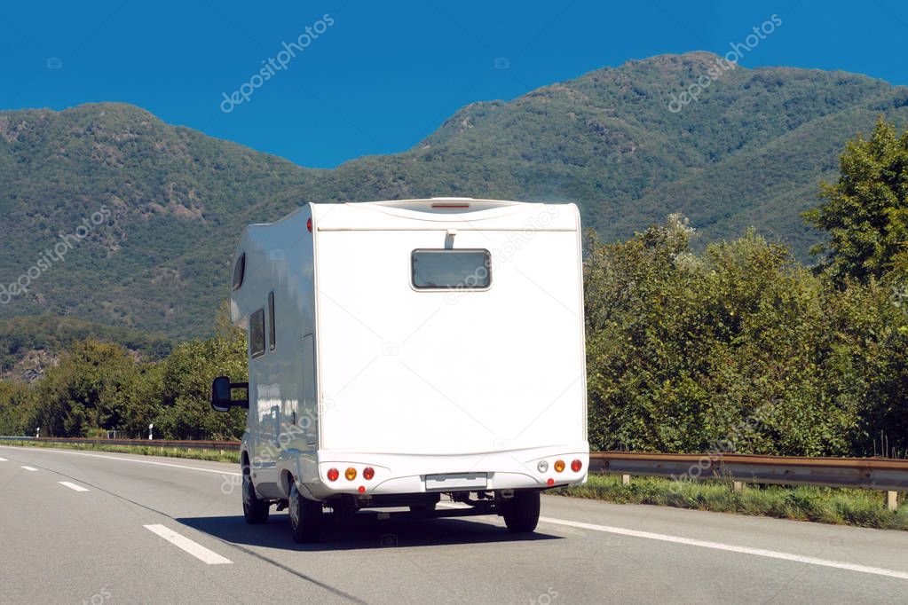 White Caravan on road in Switzerland