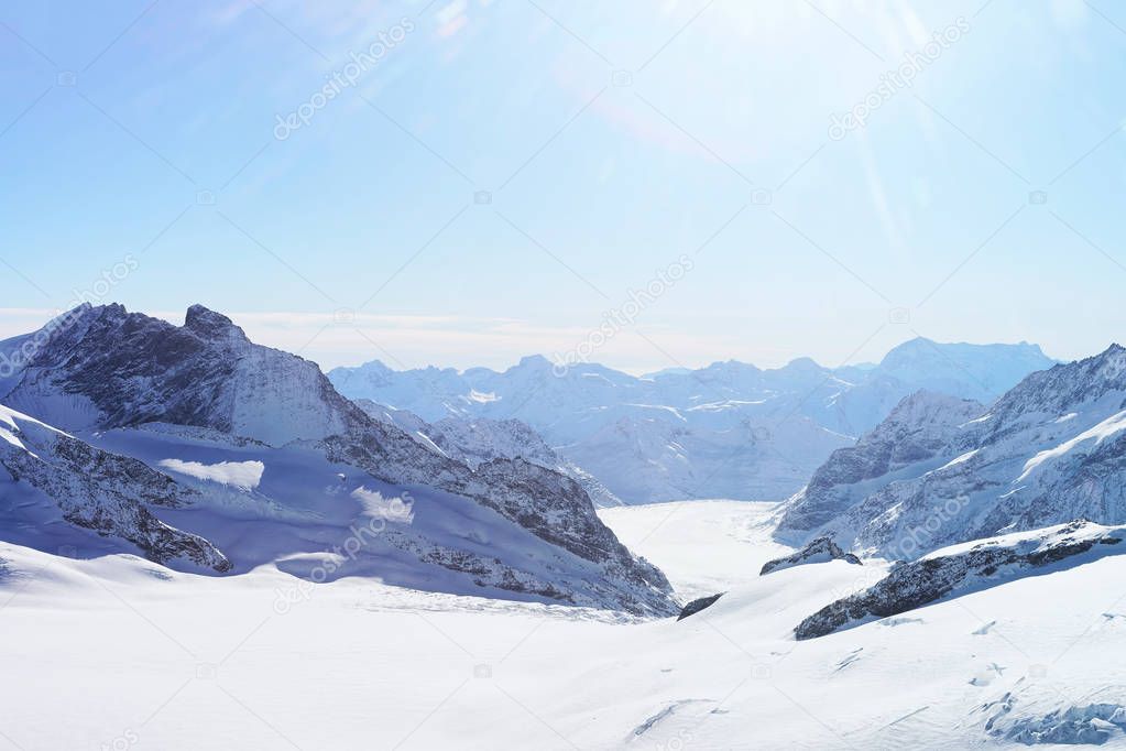 Mountain peaks ridge and Aletsch glacier in winter Swiss Alps
