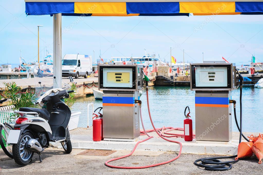 Motorcycle at petrol station for filling ships Cefalu port Sicily ...
