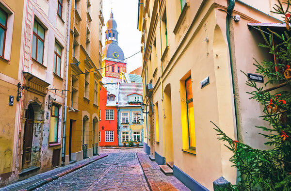 Narrow street leading to St Peter church in Old Riga