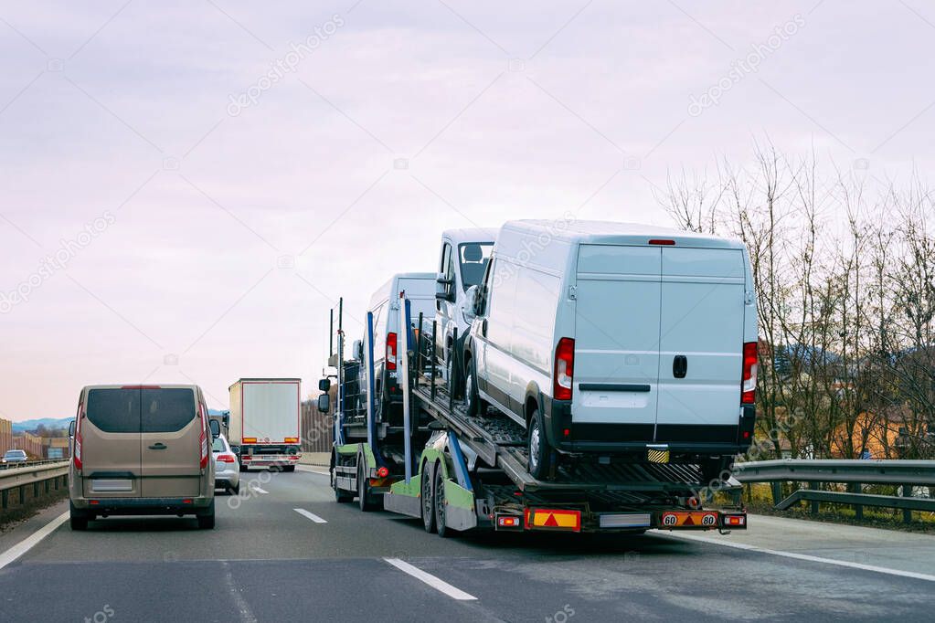 Minivan carrier transporter truck in road