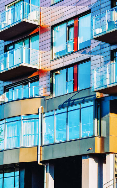 Facade with Windows in Modern residential apartment and flat building exterior. Detail of New luxury house and home complex. Part of City Real estate property and condo architecture. Balconies