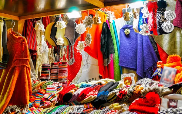 Stall with colorful woolen clothes at the Riga Christmas market reflex — Stock Photo, Image