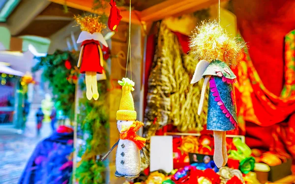 Pequeñas estatuas hechas a mano colgando en exhibición en el reflejo del mercado de Navidad de Riga —  Fotos de Stock