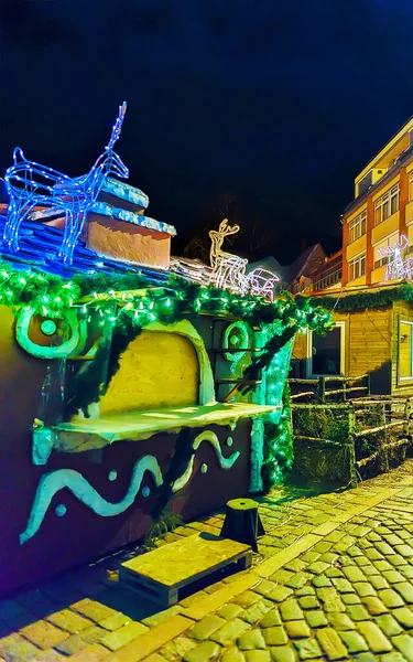 Christmas stalls decorated with glowing deer figures in old Riga reflex — Stock Photo, Image