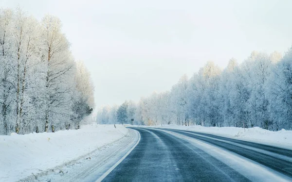 Winter road and a Snowy Forest at Cold Finland reflex — Stock Photo, Image