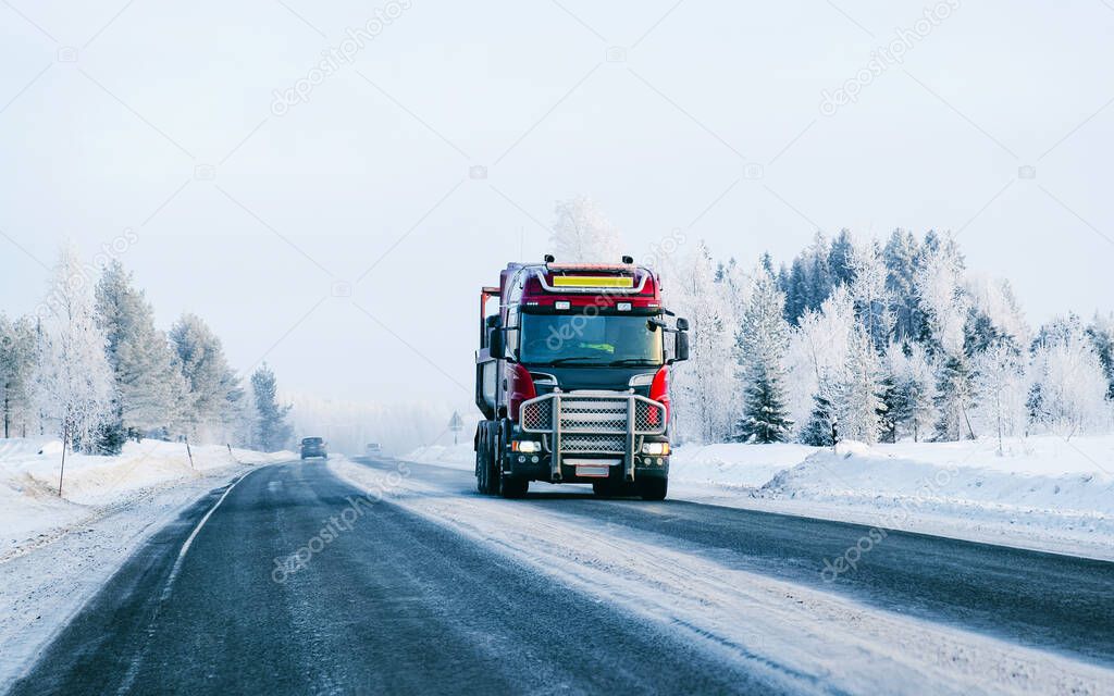 Truck in the Snowy winter Road in Finland Lapland reflex