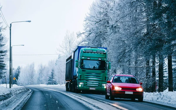 Truck at the Snowy winter Road of Finland in Lapland reflex