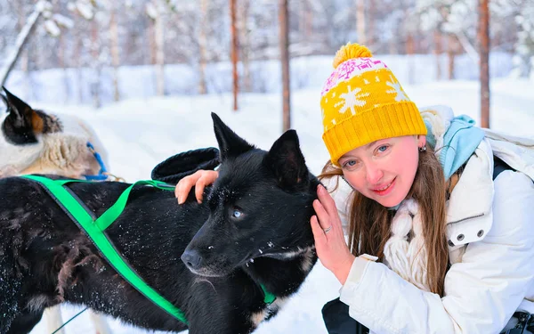 Girl with Husky dog at Finnish Lapland winter Finnish forest reflex