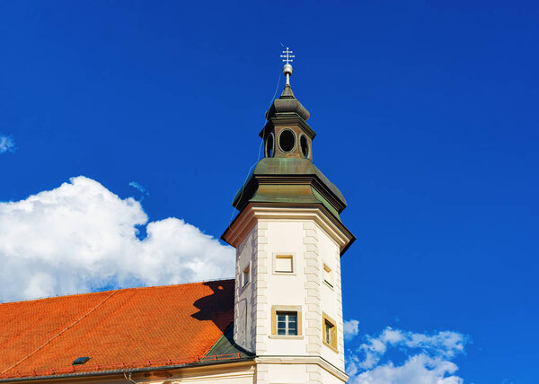 Tower of Maribor Castle on Grajski trg in Old city in Maribor in Slovenia in Europe. Cityscape with medieval museum mansion in Lower Styria in Slovenija. Travel and tourism. Blue sky and sunny day.
