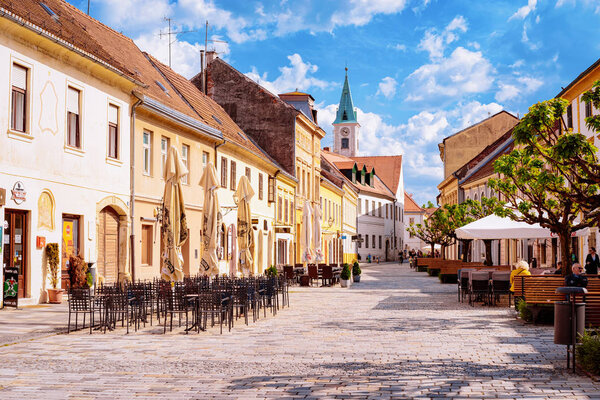 Street cafes and restaurants and people on benches in Varazdin