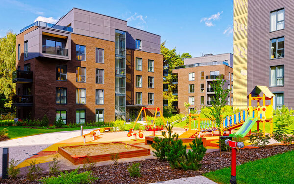 Children playing ground at architectural complex of residential buildings reflex