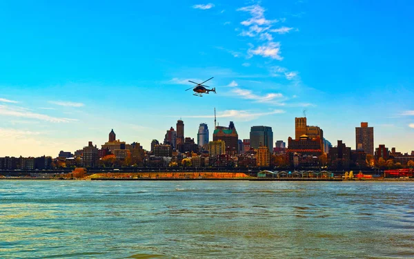 Helicopter flying over East River with reflex — Stock Photo, Image