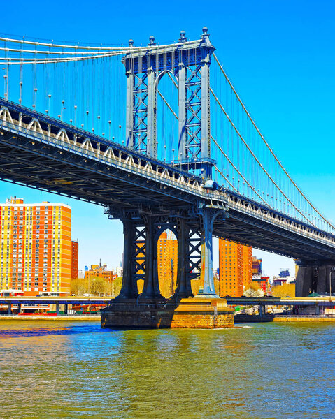 Manhattan bridge across East River, New York, USA. It is among the oldest in the United States of America. NYC, US. Skyline and cityscape. American construction