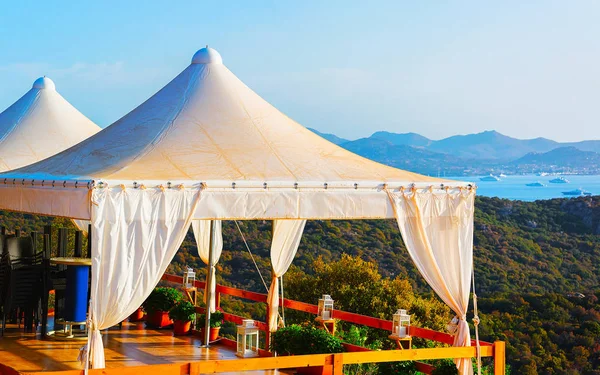 Idyllic sunrise in Costa Smeralda under canvas pavilion Sardinia reflex