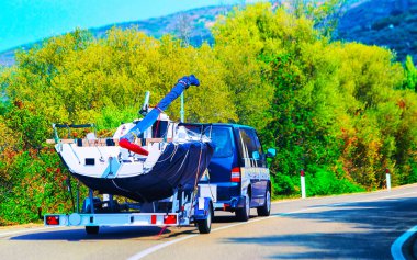 Car with motor boat at trailer on road of Olbia reflex clipart