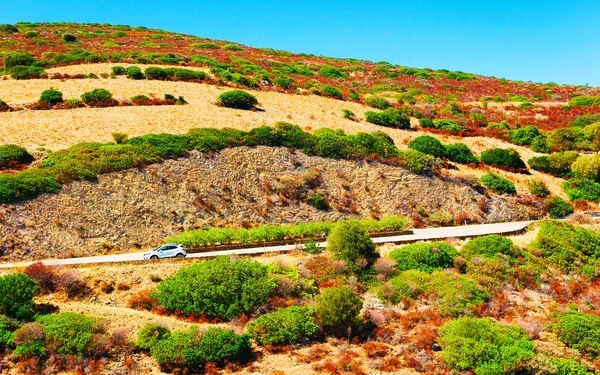 Car on road in hill at Sardinia reflex