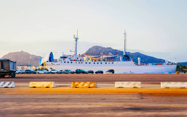 Ship in port of Olbia early morning Sardinia reflex